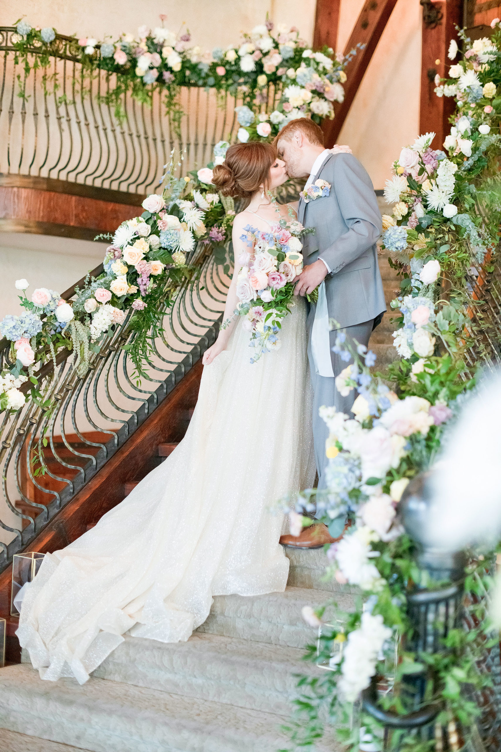 wedding kiss-first kiss-wedding portraits-floral staircase-pastel wedding theme-castle wedding-wadley farms-lindon utah