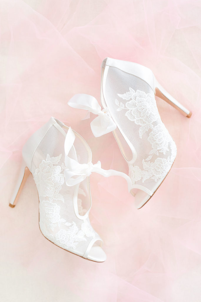 White lace shoes for the bride on her wedding day