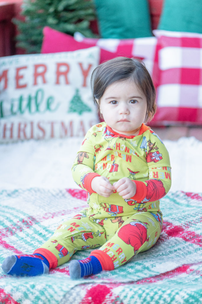 Girl Toddler in Grinch onesie for holiday family portraits in Oregon